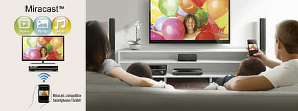 Téléviseur, personnes regardant l'écran montrant des ballons colorés, tablette connectée, haut-parleurs, télécommande